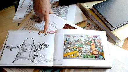 Die Fotos und Skizzen in den Alben zeigen Graffitis, Giebelbilder und Schablonenwerke.