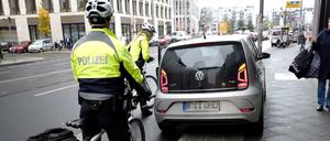 Zwei Polizisten der Fahrradstaffel der Berliner Polizei sprechen einen Falschparker an.
