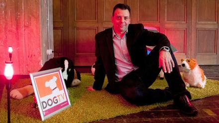 Herrchen- und Hundeversteher: Geschäftsführer Gilad Neumann posiert bei der Vorstellung von "Dog TV" mit Stofftieren in Berlin.