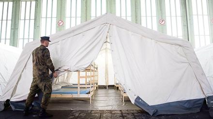 Bundeswehrsoldaten helfen bei der Aufstellung von Zelten für eine Erstaufnahmeeinrichtung für Flüchtlinge in einem Hangar des ehemaligen Flughafen Tempelhof.