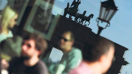 Macht mal blau. Wer kann, sollte den Tag heute nutzen: Ob im Café am Brandenburger Tor, im Biergarten am Wannsee oder auf der Wiese im Tiergarten – Hauptsache draußen. Erwartet werden wieder satte 20 Grad. Das ist für Mitte März rekordverdächtig. Foto: dpa