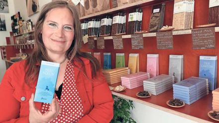 Schriftstellerin Tanja Dückers mit einer Tafel Schokolade in ihrem Laden.