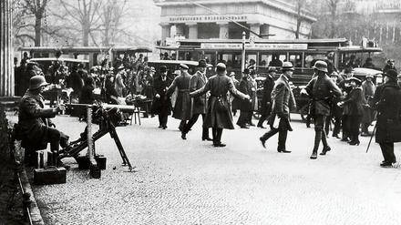 Alltag im Ausnahmezustand. Schwer bewaffnete Freikorps-Milizen gehen am 13. März 1920 auch am Leipziger Platz in Stellung – das Berliner Leben geht weiter. 