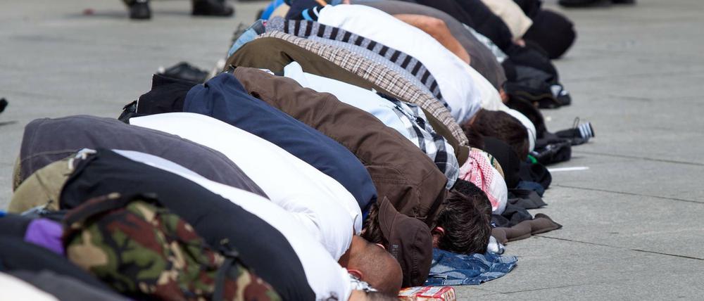 Beten auf dem Potsdamer Platz. Salafisten geben sich gerne demonstrativ fromm. Einige können jedoch offenbar tiefen Glauben mit kriminellen Aktivitäten vereinbaren 