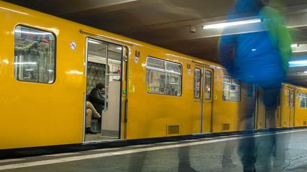 Eine U-Bahn hält in einem Berliner U-Bahnhof.
