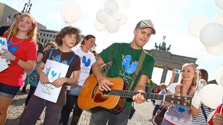 Milow spielte am Brandenburger Tor zusammen mit Schülerinnen und Schülern ein Straßenkonzert für "Schulen für Haiti".