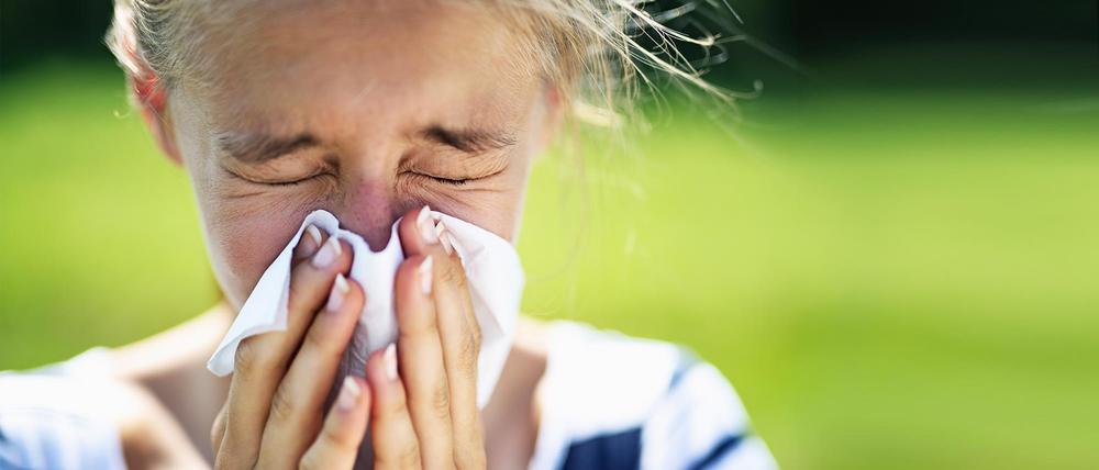 Portrait of teenage girl blowing her nose on a summer day. The girl is allergic to the pollen.
Nikon D850