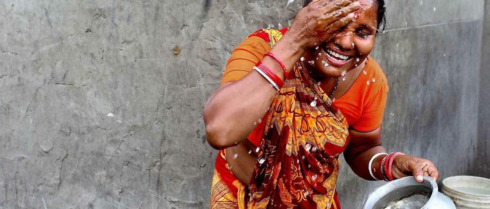 Sauberes Wasser ist eines der Themen, für die man abstimmen kann. Hier wäscht sich eine Frau im Slum von Komplapur.