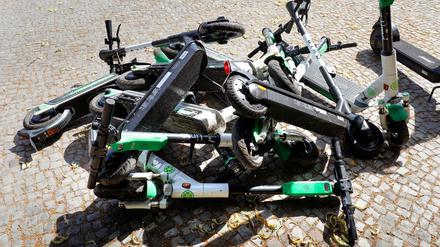 Umgestürzte E-Roller liegen auf einem Gehweg in Berlin.