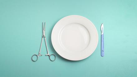 Close up of a pair of pincers  and scalpel by a plate, post operative food in hospital.  What can I eat after an operation?