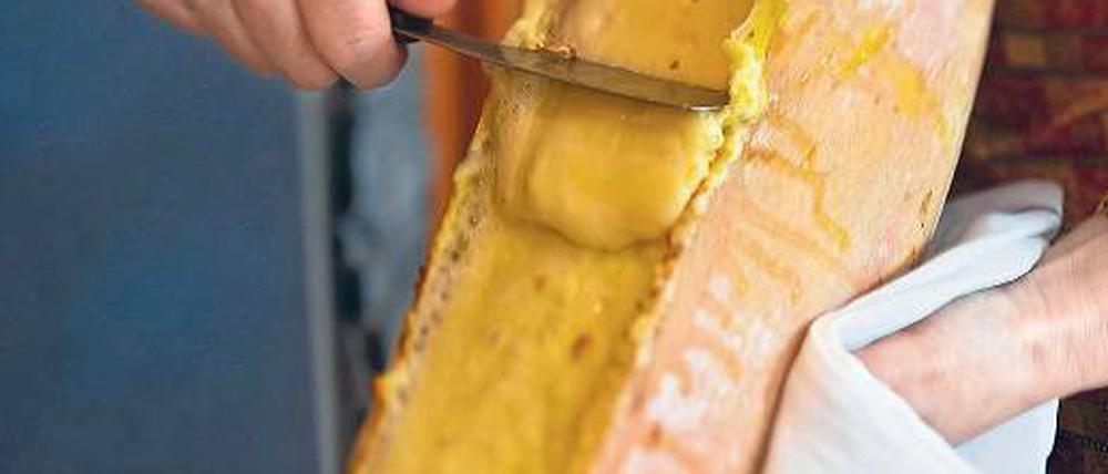 Die Schnittfläche des Käses großer Hitze aussetzen, das Weiche mit dem Messer auf einen Teller schaben – so geht Raclette. 