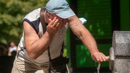 Ein Mann versucht, sich in einem Brunnen im Retiro-Park in Madrid abzukühlen.