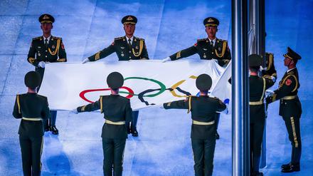 Soldaten von Chinas Volksbefreiungsarmee hissen während der Eröffnungsfeier im Pekinger Vogelneststadion die olympische Flagge.