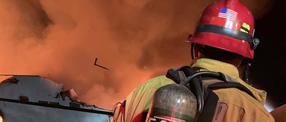 Ein Feuerwehrmann versucht, das vor der kalifornischen Küste in Brand geratene Schiff zu löschen.