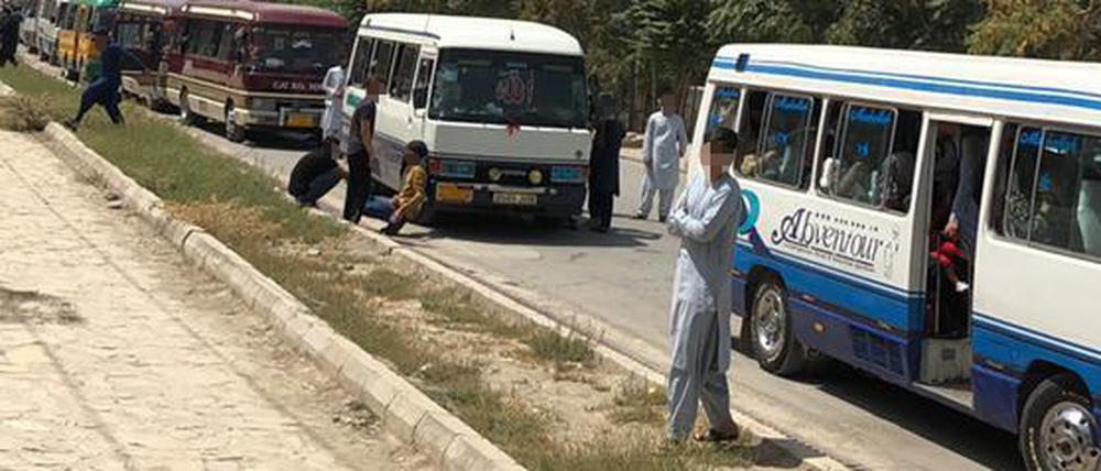 Busse mit Studierenden auf den Straßen Kabuls. 