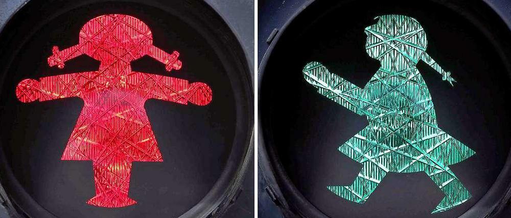 Eine rot (l) und eine grün leuchtende Ampelfrau an einer Fußgängerampel in Sonthofen (Bayern).