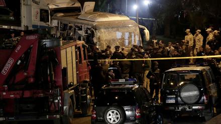 Sicherheitskräfte stehen nach einem Bombenanschlag auf einen Bus am Anschlagsort.