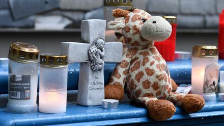 Ein Stofftier und Kerzen haben Menschen vor dem Haus niedergelegt, in dem die fünf toten Kinder gefunden wurden.