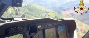 Ein italienischer Feuerwehrhubschrauber sucht die Absturzstelle eines Hubschraubers ab. Sieben Menschen haben bei einem Hubschrauberunglück im italienischen Apennin-Gebirge ihr Leben verloren. 