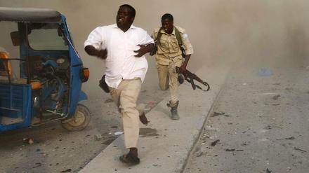 Sicherheitskräfte fliehen vor der Explosion in Mogadishu.