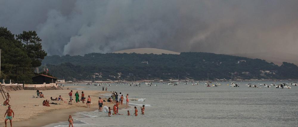 Rauch steigt über einen Wald in der Nähe der französischen Sanddüne Dune du Pilat auf. 