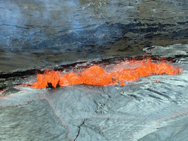Lava spritzt am Rande eines Lavasees des Kilauea Vulkans auf Big Island nach oben.