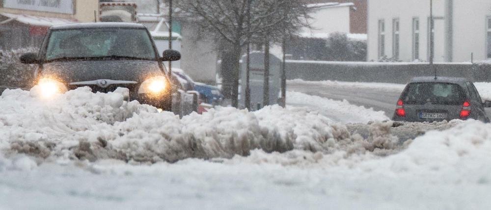 Bayern, Straßkirchen: Autos fahren auf schneebedeckten Straßen. 