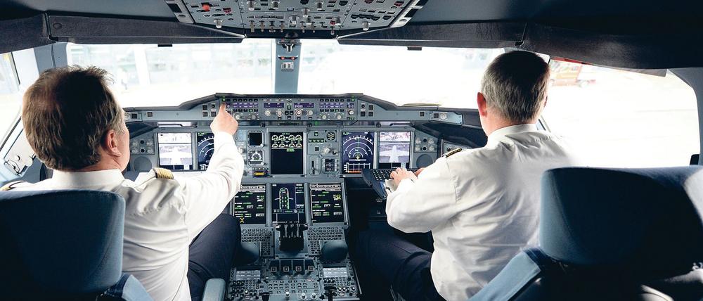 Zwei Piloten sitzen am 05.06.2014 auf dem Flughafen in Hamburg im Cockpit eines Lufthansa-Airbus A 380.