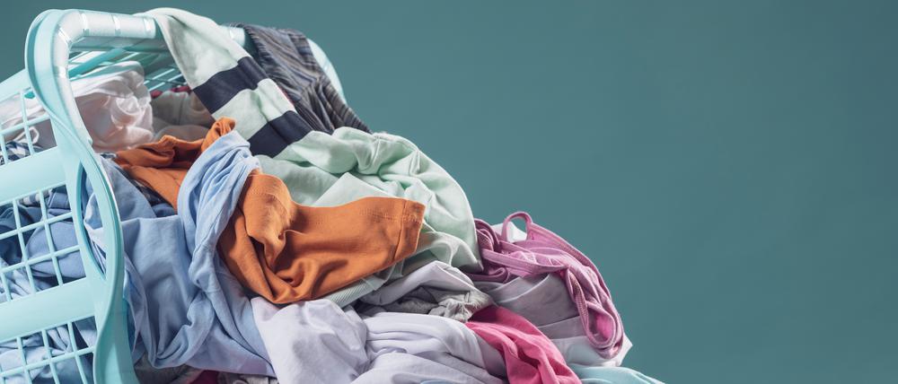 Heap of dirty clothes and laundry basket, household and washing concept
