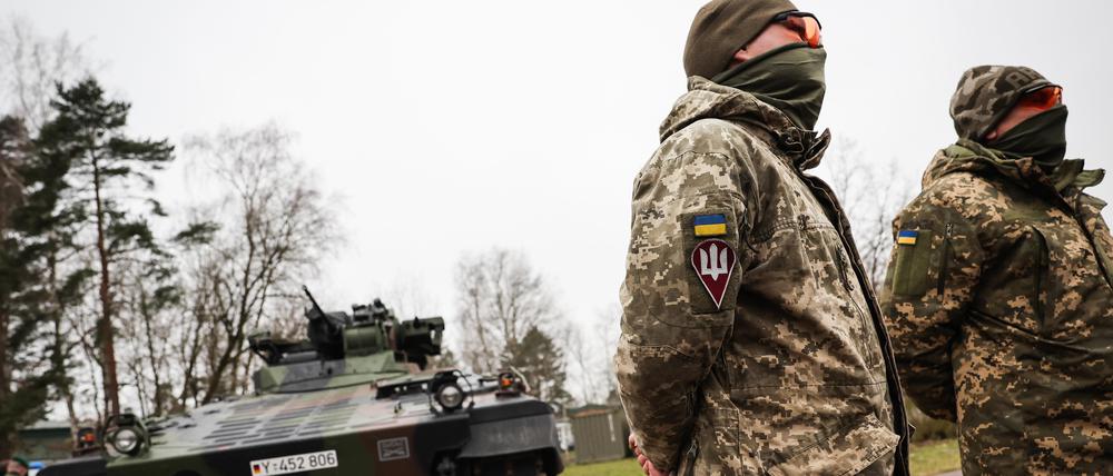 Die Ukrainischen Soldaten Vitalii (r) und Anatolii stehen vor einem Schützenpanzer Marder bei einem Besuch von Bundesverteidigungsminister Pistorius bei der Panzertruppenschule im niedersächsischen Munster.