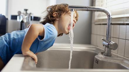 Small boy drinking water