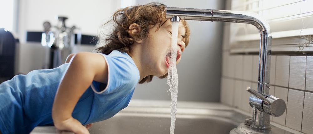 Small boy drinking water