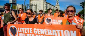 Klimaaktivisten der Letzten Generation beim Slow Walk auf der Karl-Marx-Allee.
