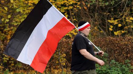 Ein Teilnehmer mit einer schwarz-weiß-roten Reichsflagge während einer Demonstration von Reichsbürgern und anderen Rechtsextremen in Potsdam im Jahr 2020. 