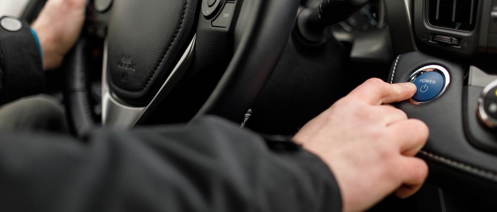 Car driver starting the engine Start, stop engine button.