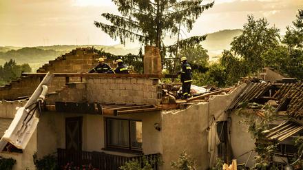 Einsatzkräfte des THW begutachten Schäden an einem Haus. In Asweiler in der Gemeinde Freisen (Landkreis St. Wendel) entwickelte am Dienstagabend ein Sturm erhebliche Zerstörungskraft und wütete in einer Schneise von etwa 100 Metern, wie das Lagezentrum der Polizei mitteilte. 