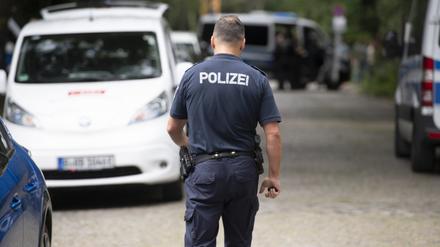 20.07.2023, Brandenburg, Kleinmachnow: Ein Polizist läuft bei einer Suchaktion nach einem freilaufenden gefährlichen Wildtier im Bereich der südlichen Landesgrenze von Berlin eine Straße entlang. Ein gefährliches Wildtier ist in der Nacht zum Donnerstag in Brandenburg entlaufen und hat eine große Suchaktion ausgelöst. Wie die Polizei auf Anfrage der Deutschen Presse-Agentur mitteilte, suchten Einsatzkräfte mit Hubschraubern in Kleinmachnow und angrenzenden Gemeinden nach dem Tier. Foto: Paul Zinken/dpa +++ dpa-Bildfunk +++