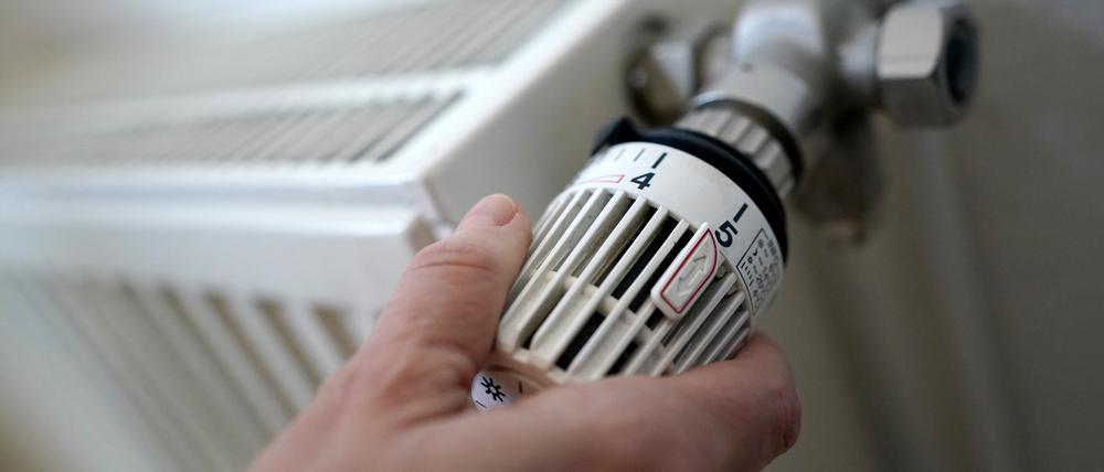 Eine Frau dreht an einem Heizungsthermostat. Das Heizungsgesetz wird es nun doch nicht vor der Sommerpause durch den Bundestag schaffen.