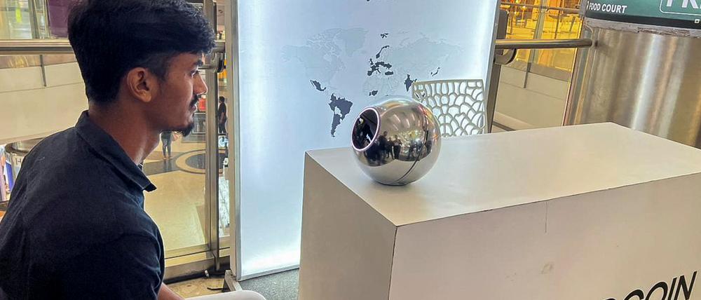Kaleem, 22, an engineer in Bengaluru, signs up for WorldCoin by having his eyes scanned by the spherical device in Mantri Square Mall in Bengaluru, India July 25, 2023. REUTERS/Medha Singh