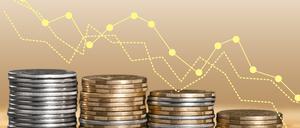 Inflation. The recession of the economy and the euro. The concept of economic stock exchange. Stacks of coins and a graph arrow pointing down.