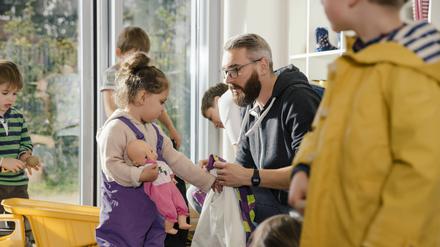 Erst das Kind, dann die Puppe – Vorbereitung für den Ausflug im Kindergarten.