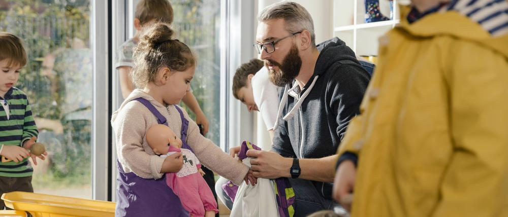 Erst das Kind, dann die Puppe – Vorbereitung für den Ausflug im Kindergarten.