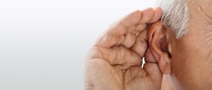 Close-up Of A Senior Man Trying To Hear Hand Over Ear