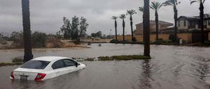 CATHEDRAL CITY, CALIFORNIA - AUGUST 20: A car is partially submerged in floodwaters as Tropical Storm Hilary moves through the area on August 20, 2023 in Cathedral City, California. Southern California is under a first-ever tropical storm warning as Hilary impacts parts of California, Arizona and Nevada. All California state beaches have been closed in San Diego and Orange counties in preparation for the impacts from the storm, which was downgraded from hurricane status.   Mario Tama/Getty Images/AFP (Photo by MARIO TAMA / GETTY IMAGES NORTH AMERICA / Getty Images via AFP)