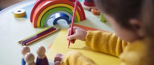 Preschooler painting and coloring