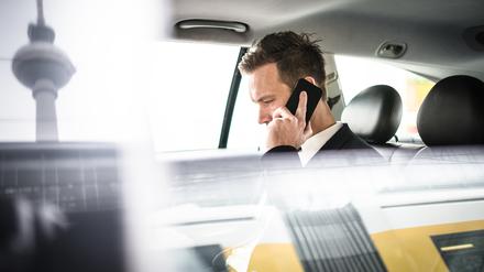 businessman on the phone in the taxi