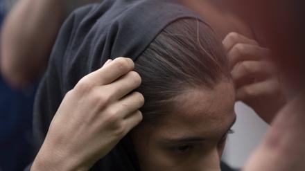 Iran-Moharram Carnival Marking Ashura An Iranian woman adjusts her headscarf while attending for watching a religious carnival marking Ashura.