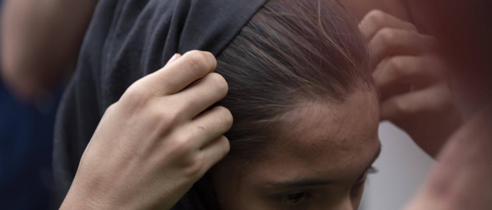 Iran-Moharram Carnival Marking Ashura An Iranian woman adjusts her headscarf while attending for watching a religious carnival marking Ashura.