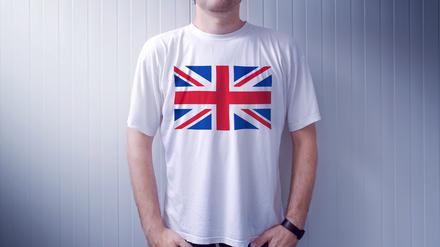 Man wearing white shirt with United Kingdom flag print, adult male person supporting Great Britain