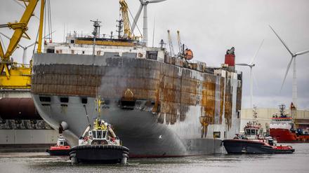 This photograph taken on September 21, 2023, shows the Panamanian-registered car carrier ship Fremantle Highway ship being towed from the Eemshaven to the port of Rotterdam, where it is planned to be dismantled. A fire broke out on the ship late on July 25, 2023, killing one crew member, and prompting a massive effort to extinguish the flames. The ship was carrying more than 3,700 cars at the time of the fire. 